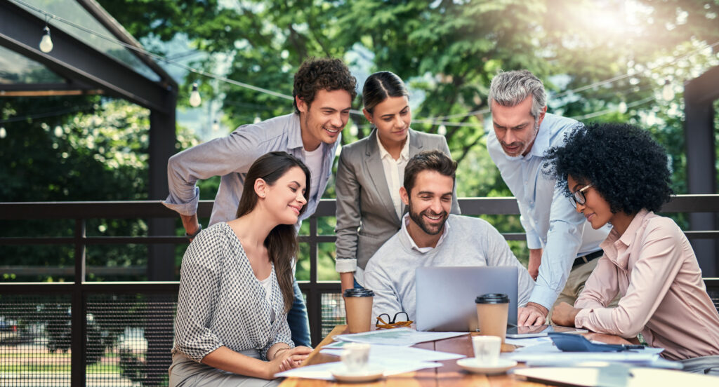 team of professional content writers looking at laptop in happiness