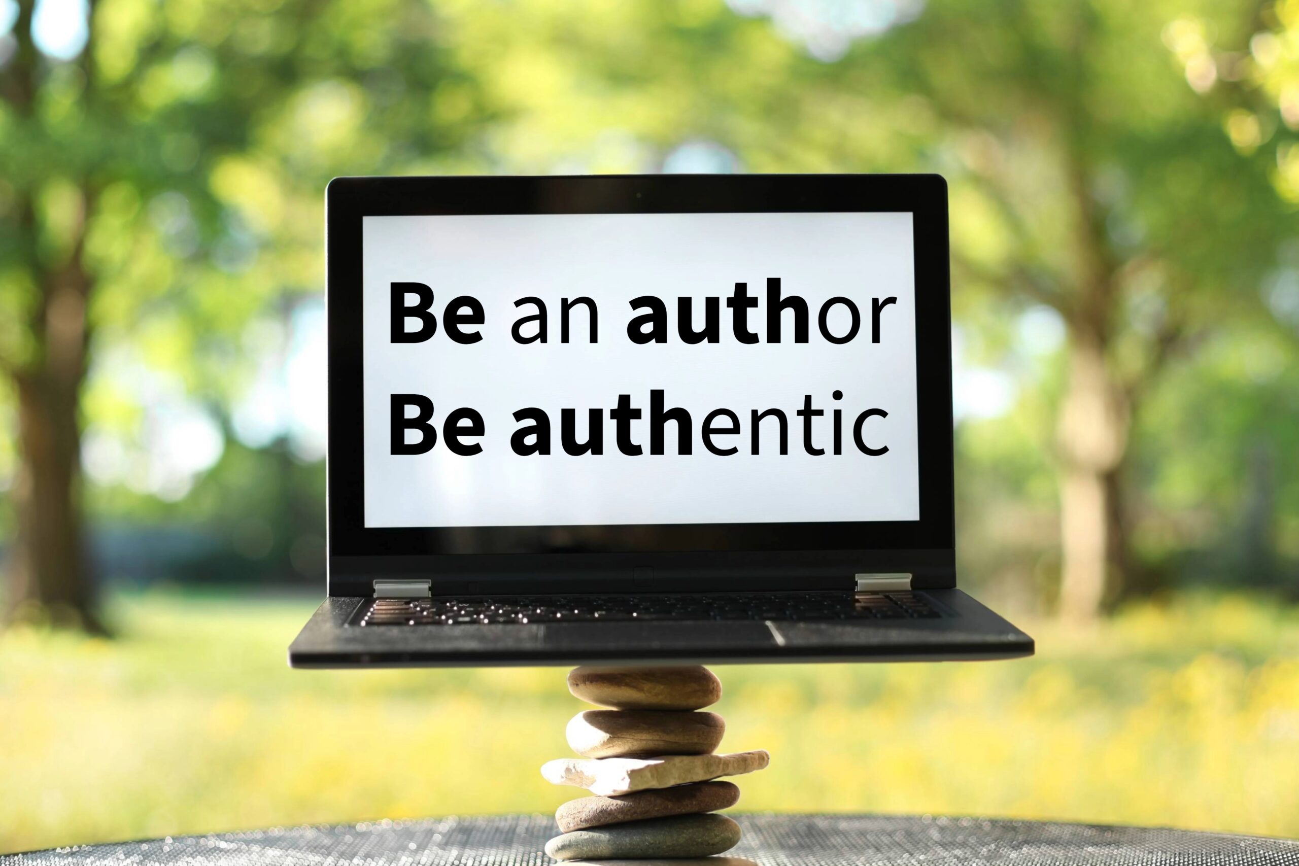 Laptop screen showing the words 'Be an author Be authentic'.