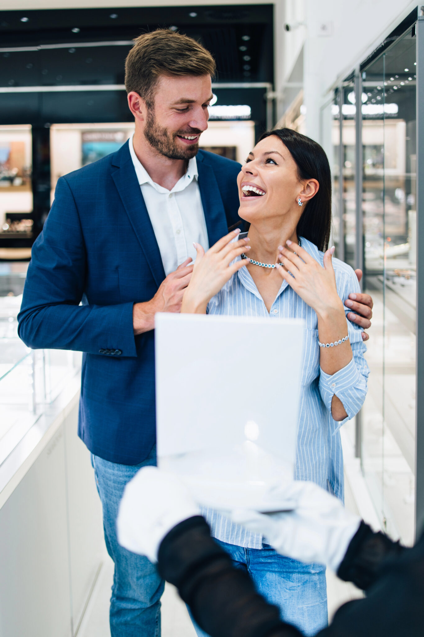 Happy couple shopping for engagement rings at a Calgary jewelry store