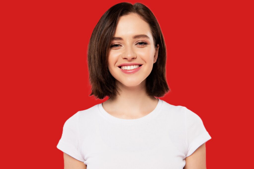 Red in branding: Smiling women dressed in white shirt and red background.