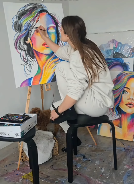 HelgaWildArt painting in her studio